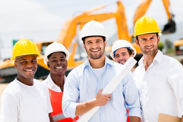 Happy group of working men at a construction site